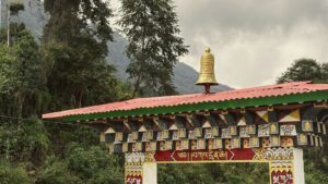 Traditional bhutanese archway with prayer flags and bell