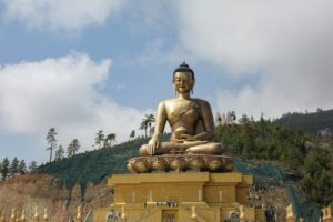 gold buddha statue under cloudy sky during daytime