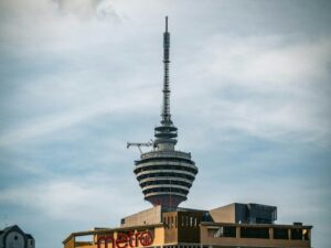 a tall tower with a sign on top of it