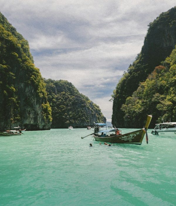 four wooden boat on teal sea