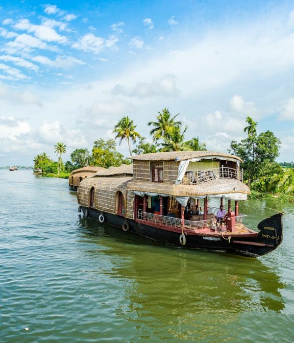 A traditional houseboat on the palm-lined backwaters of Alappuzha, India